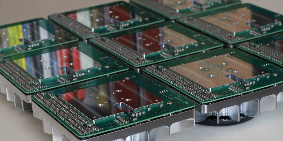 Rows of lighting-fixture circuit boards on aluminum housings