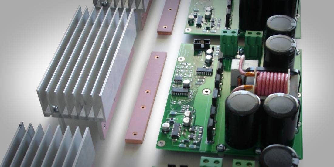 Power converter circuit board beside aluminum heat sinks